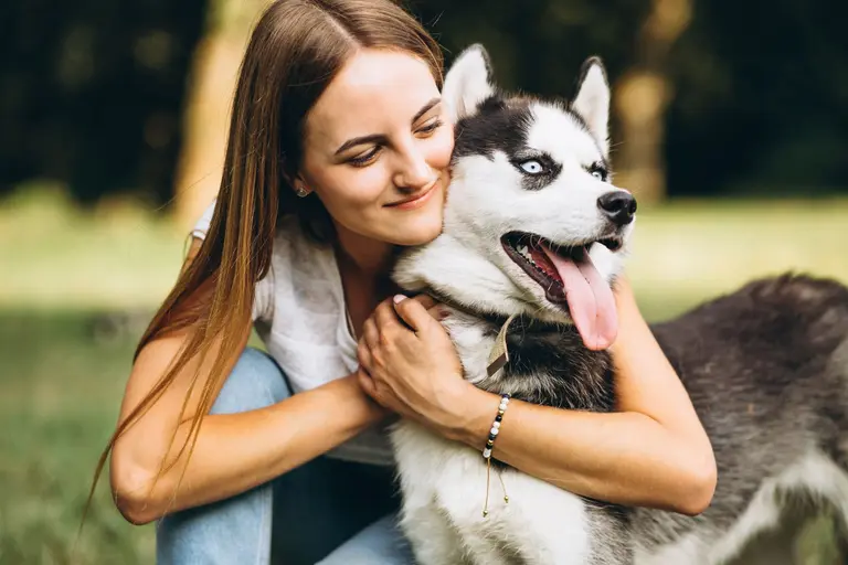 A dog and its favourite person share a moment in the park